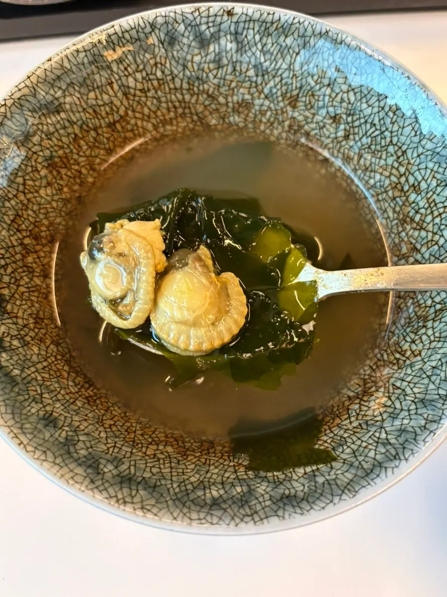 A seaweed wrap of abalone butter rice topped with pickles
