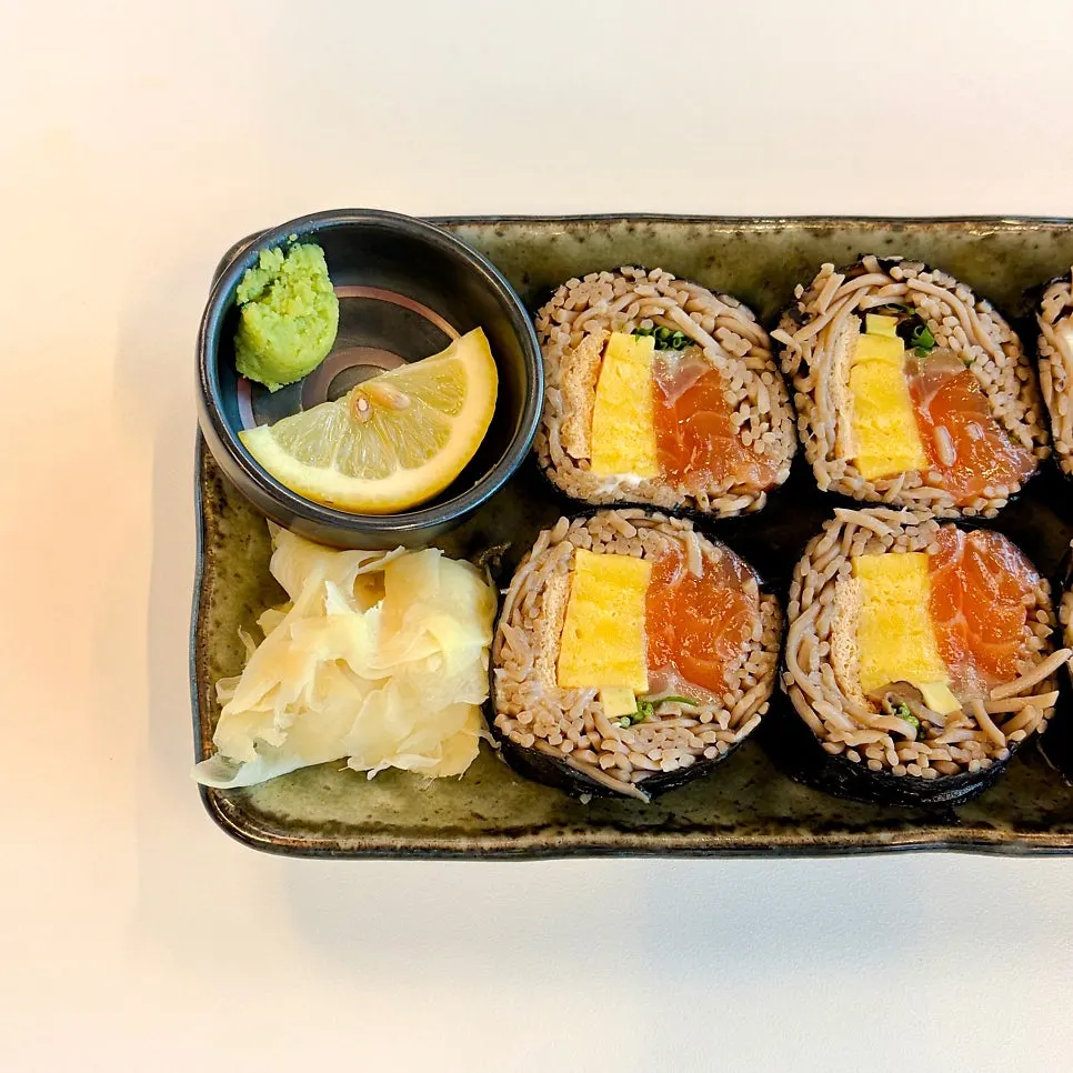 Close-up of buckwheat gimbap topped with raw salmon
