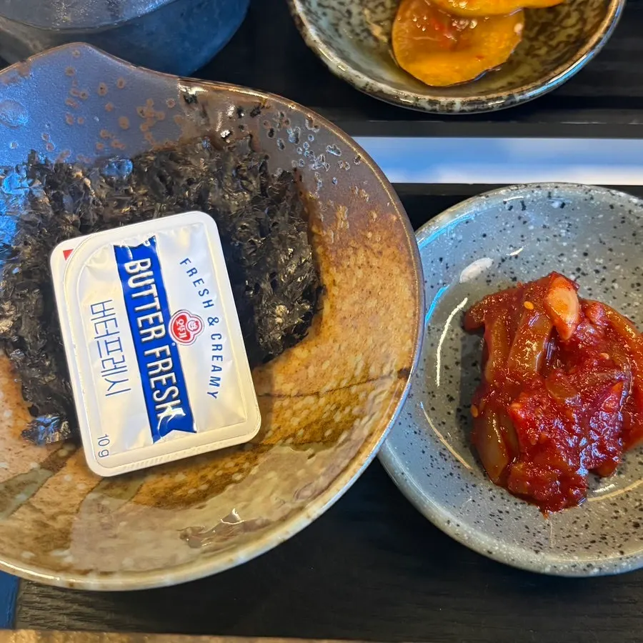 Salted seafood, pickles, seaweed, and butter side dishes