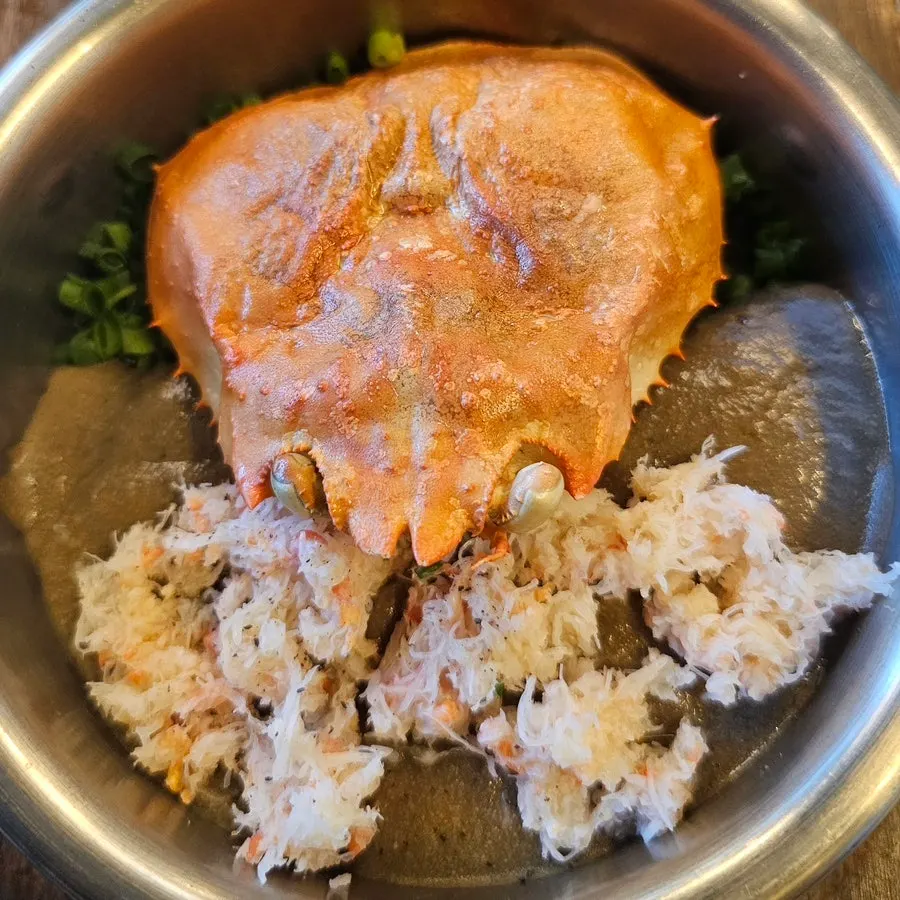 Crab pot rice topped with a crab shell