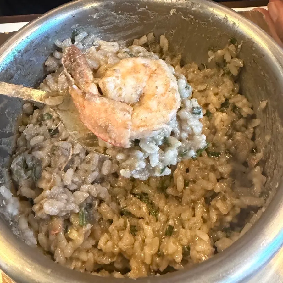 A big spoonful of crab pot rice lifted up