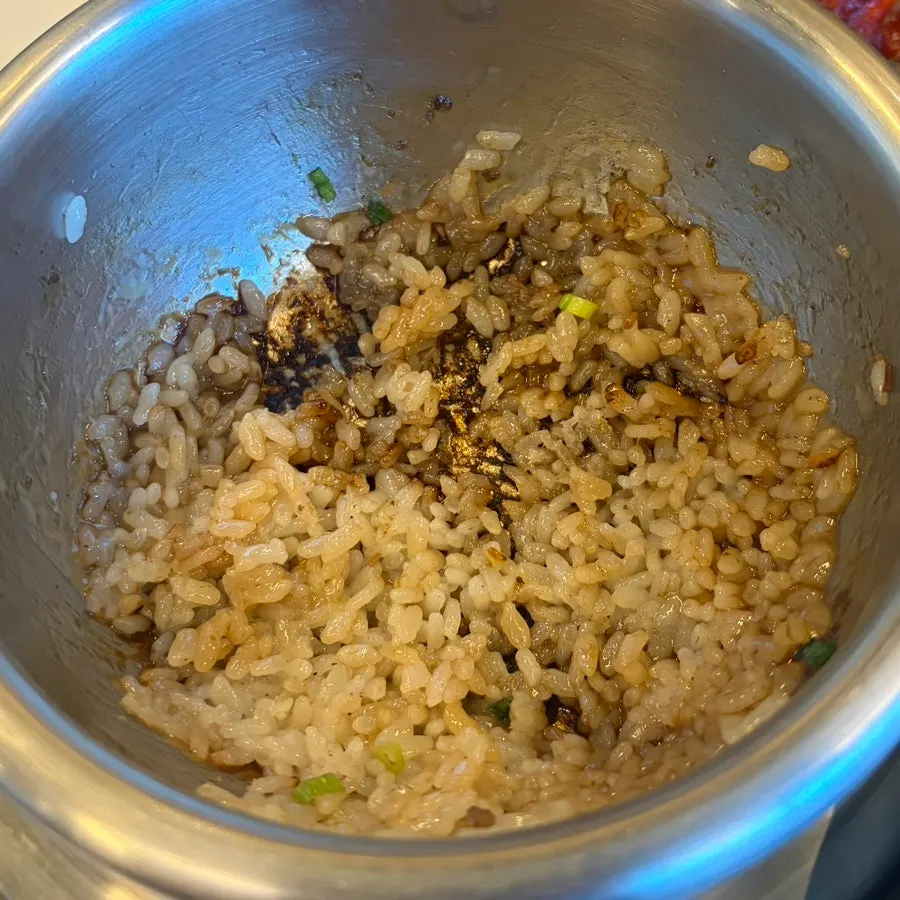 A spoonful of scorched rice with salted seafood