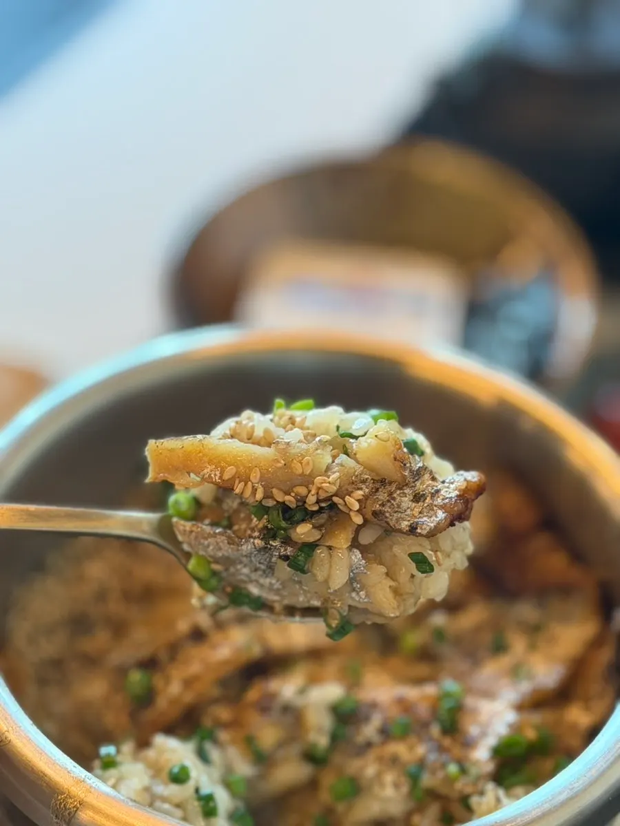A spoonful of seaweed soup with scallop meat