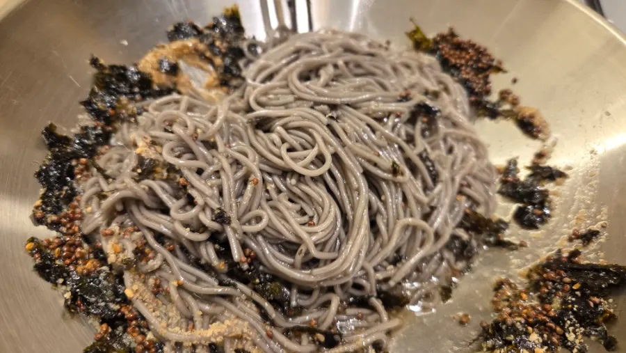 Close-up of deul-gireum hamheung-myeon topped with whole sesame seeds