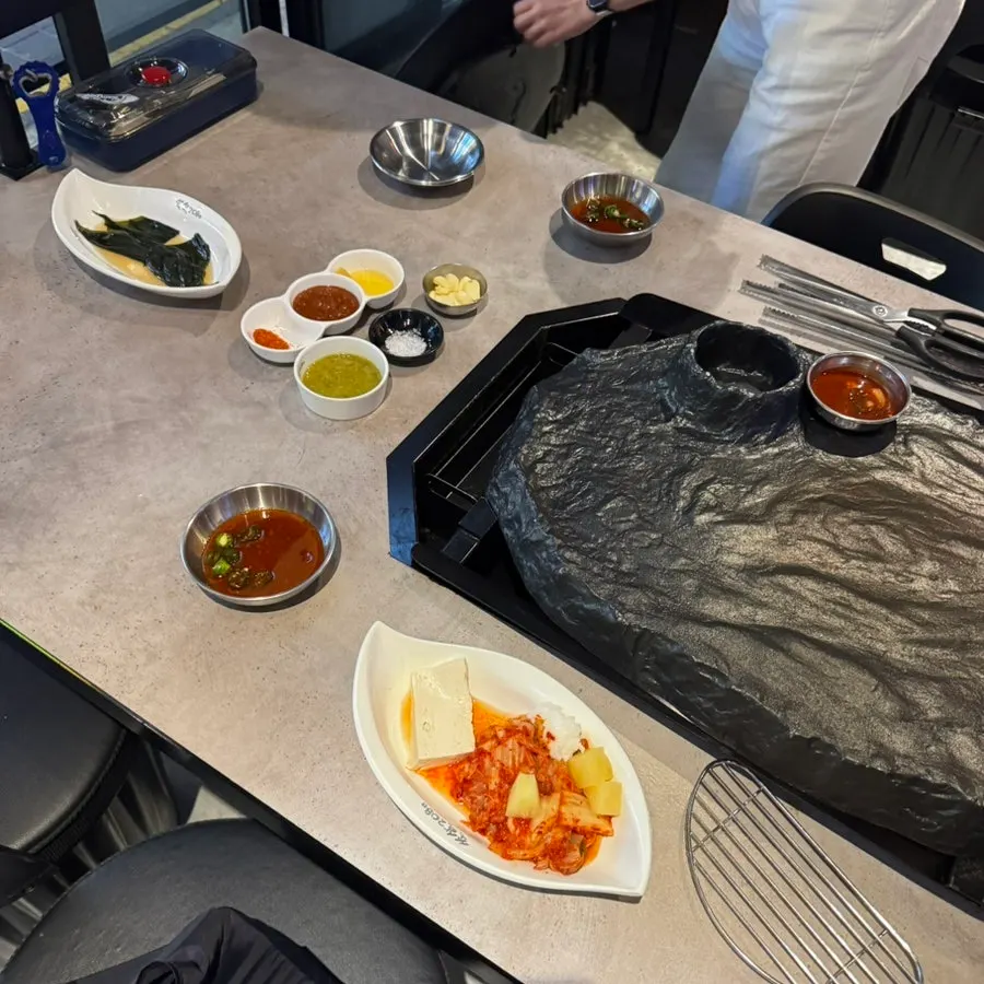 Basic table setting with shredded scallions, myeongi namul, and various sauces