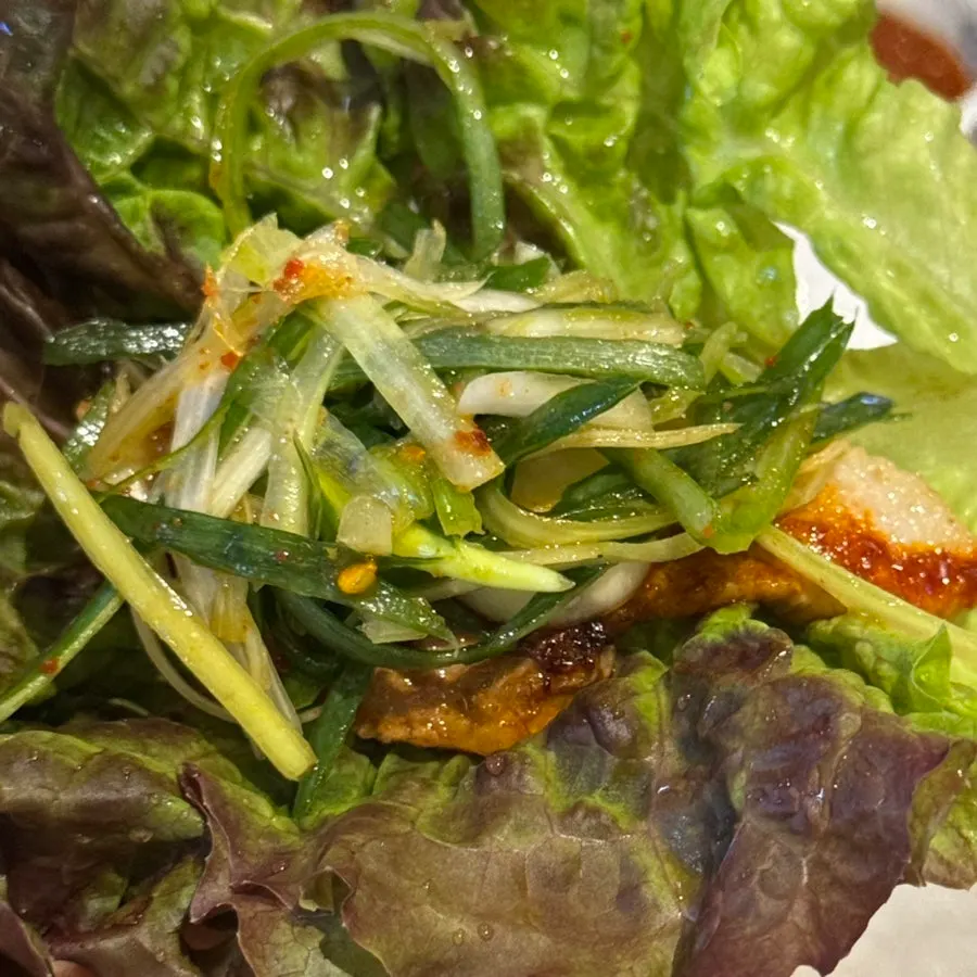 A generous lettuce wrap loaded with meat and vegetables