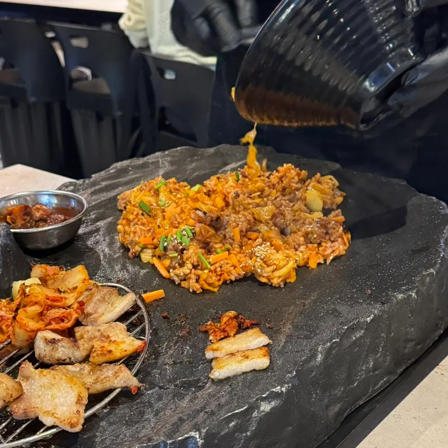 Rice noodles served alongside grilled meat on the table