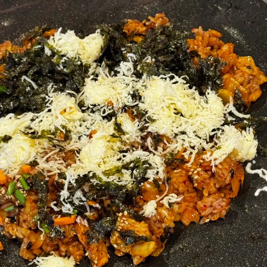 Kimchi fried rice topped with cheese and seaweed