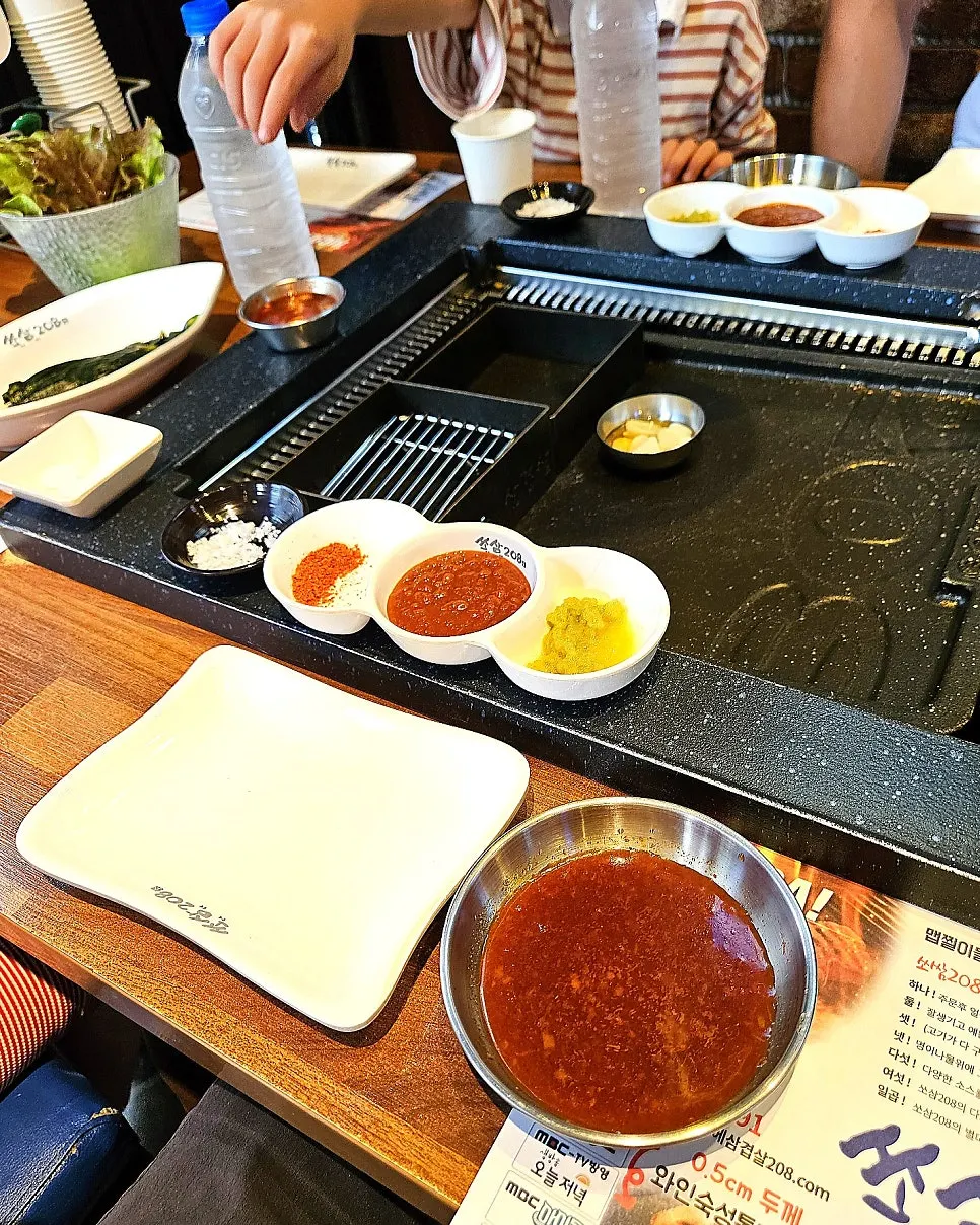 Side dishes and sauces set up at Ssosam 208 Siheung Baegot Branch