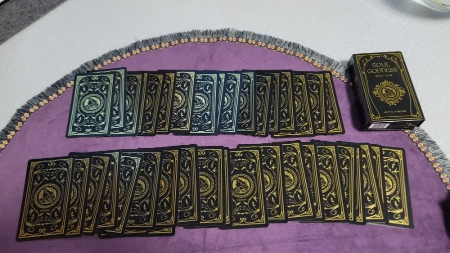 SoulGoddess cards held in a hand