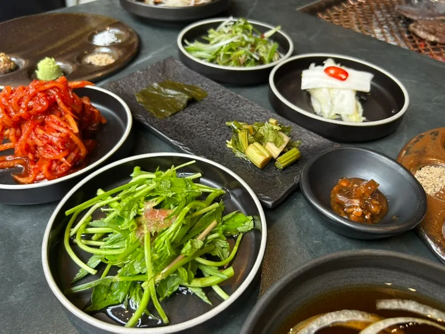 Table spread of pickles, baek-kimchi and other side dishes