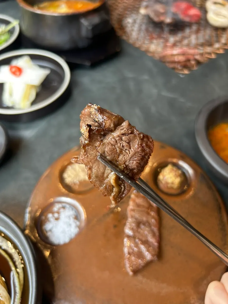 A slice of grilled sirloin dipped in salt only