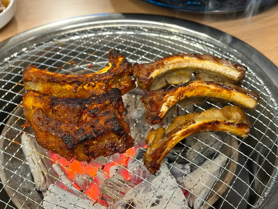 Partially cooked pork ribs finishing on the grill