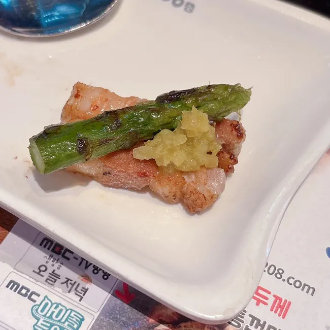 Whole onion and asparagus grilling together on the tabletop grill