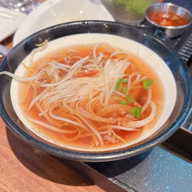 Spicy kimchi rice noodle soup served as a default side