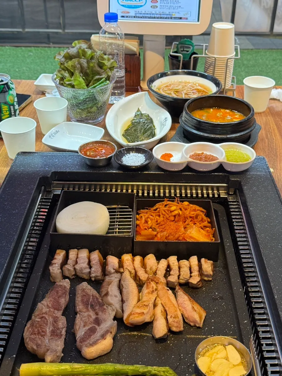 Staff grilling aged Korean pork on the grill