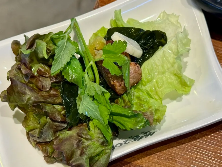 A piece of meat topped with browned kimchi