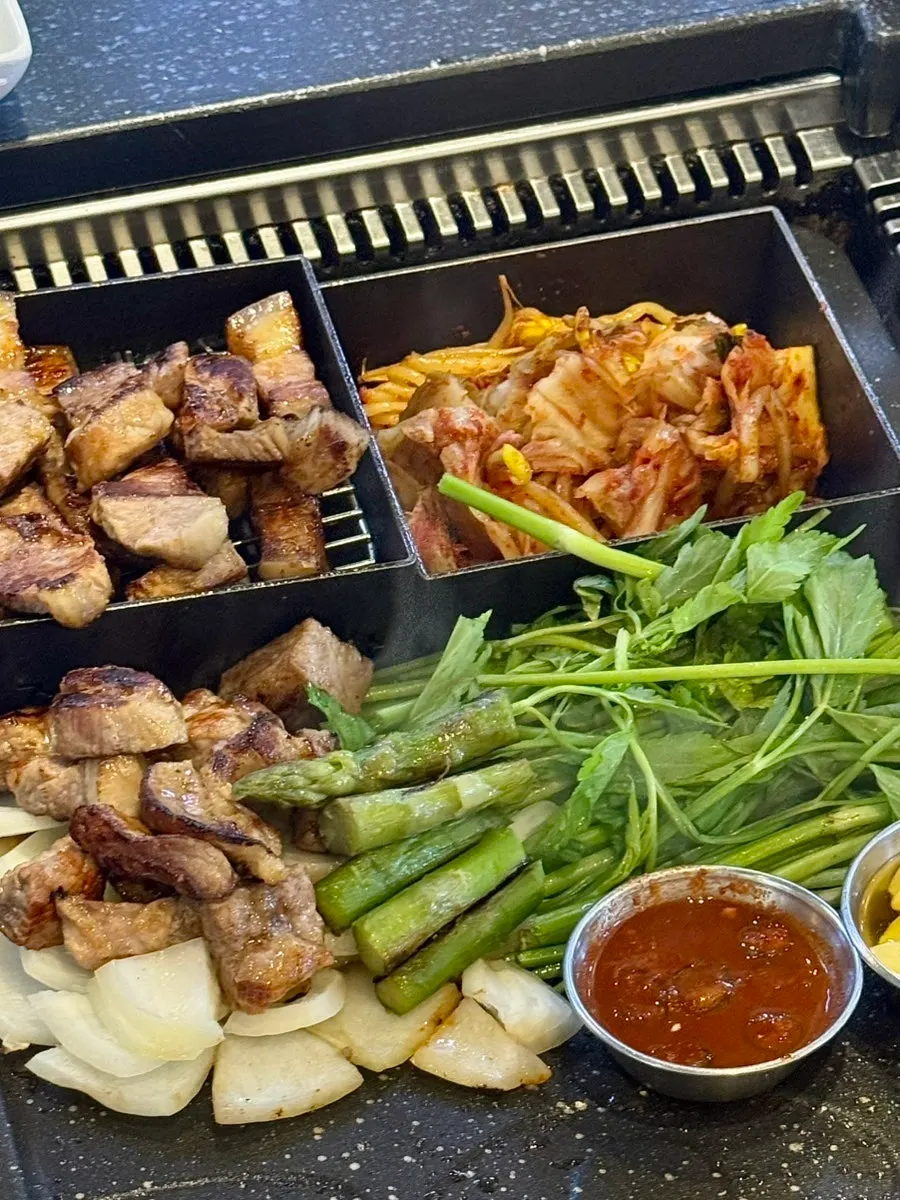 Meat and side dishes laid out together on the table