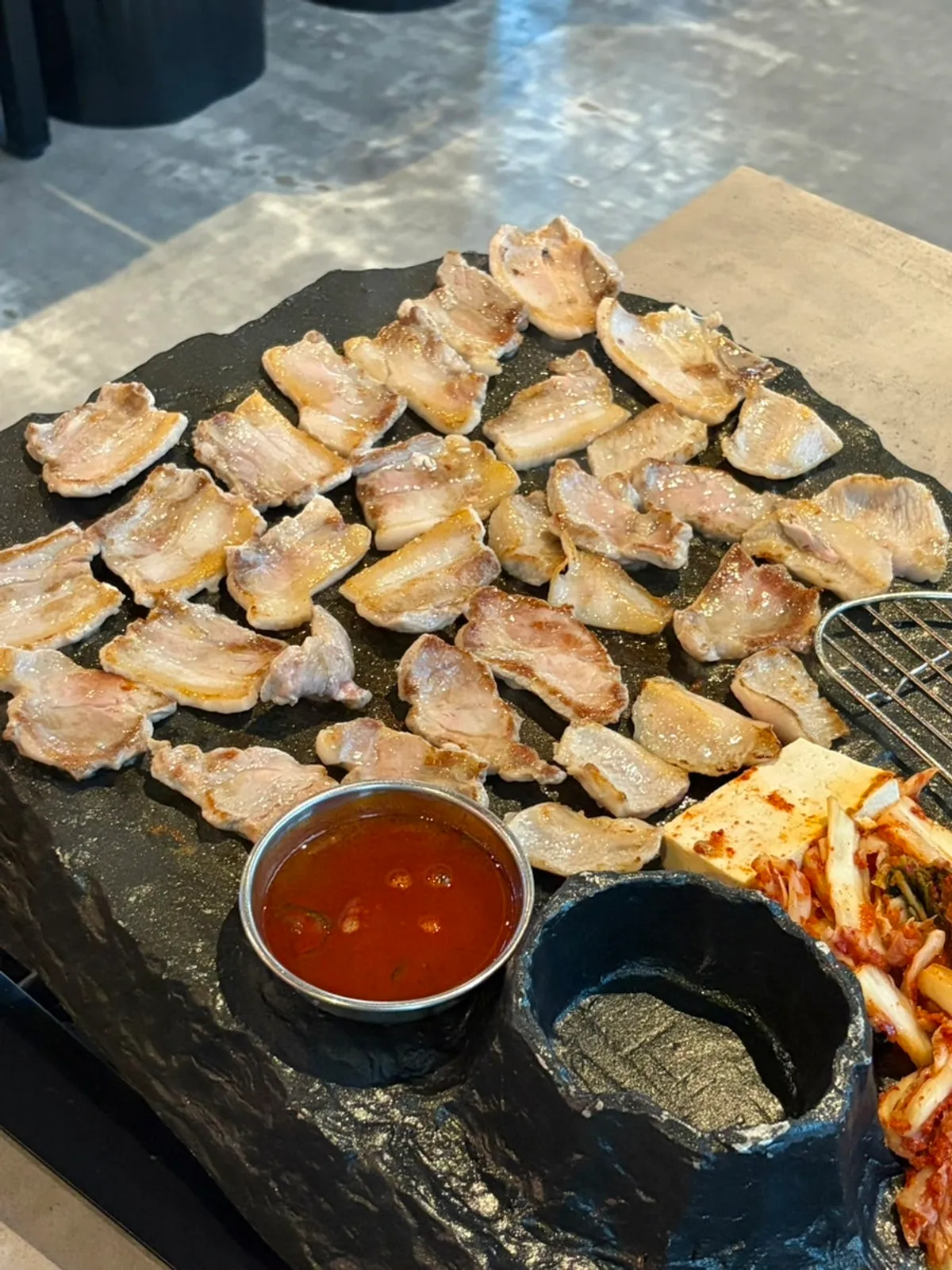 Signature stone-grill pork belly at Ssosam 208, a Suwon Station BBQ restaurant