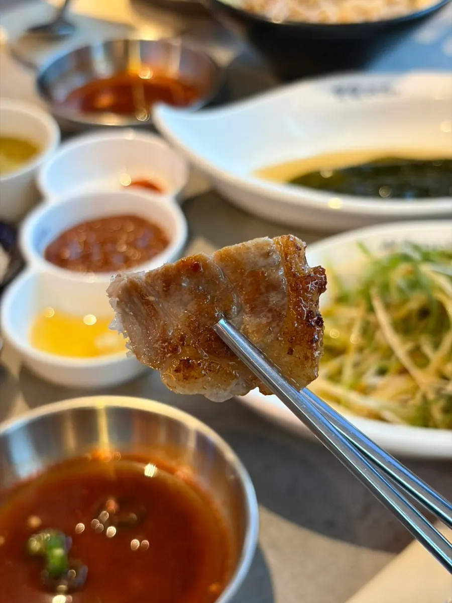 Kimchi grilling alongside meat on the stone plate
