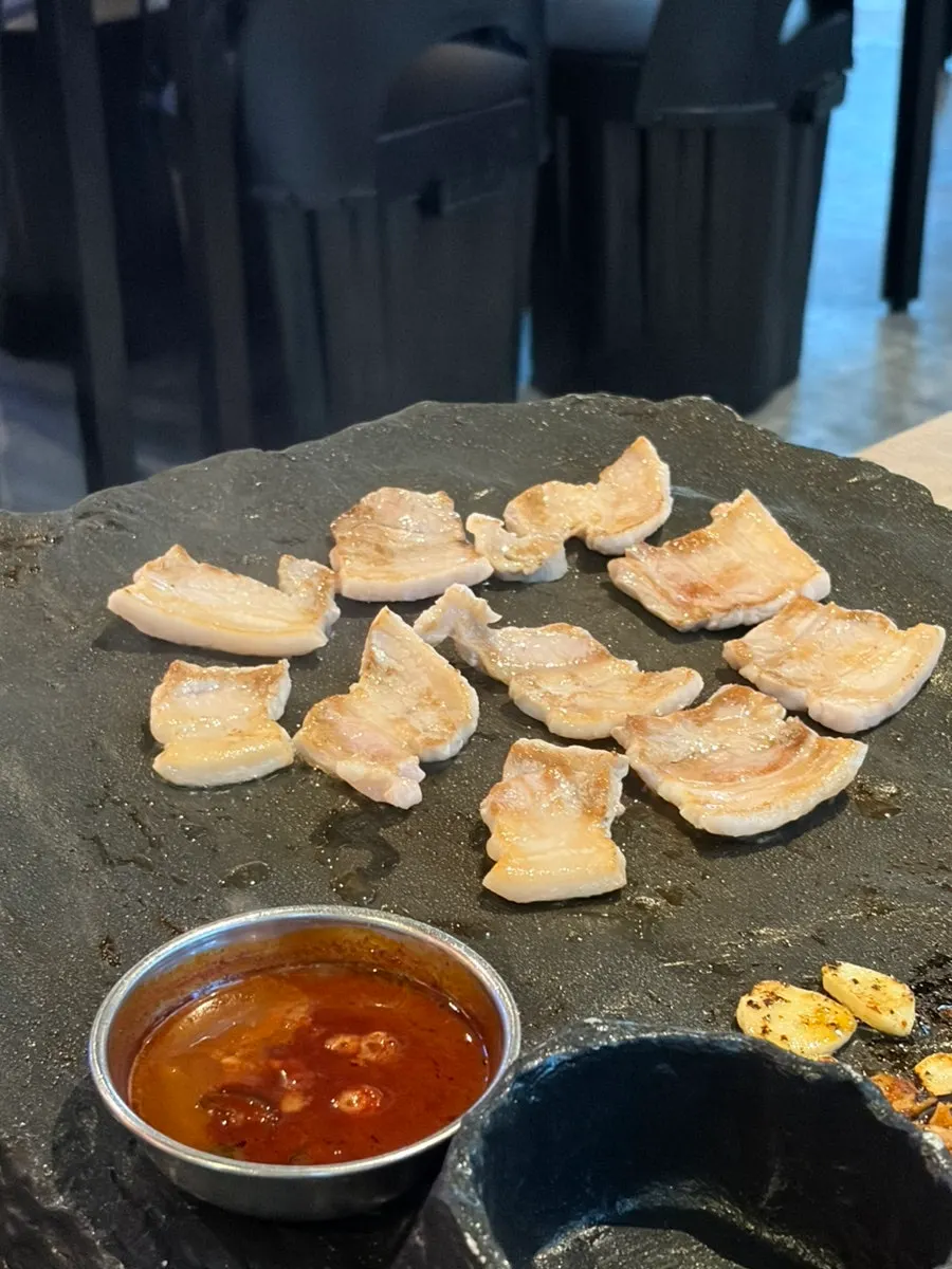 Extra serving of pork belly grilling on the stone plate