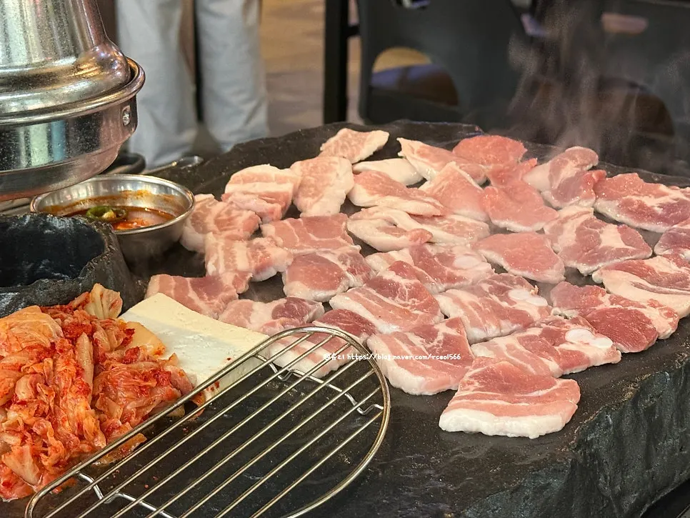 Grill piled high with meat cooking