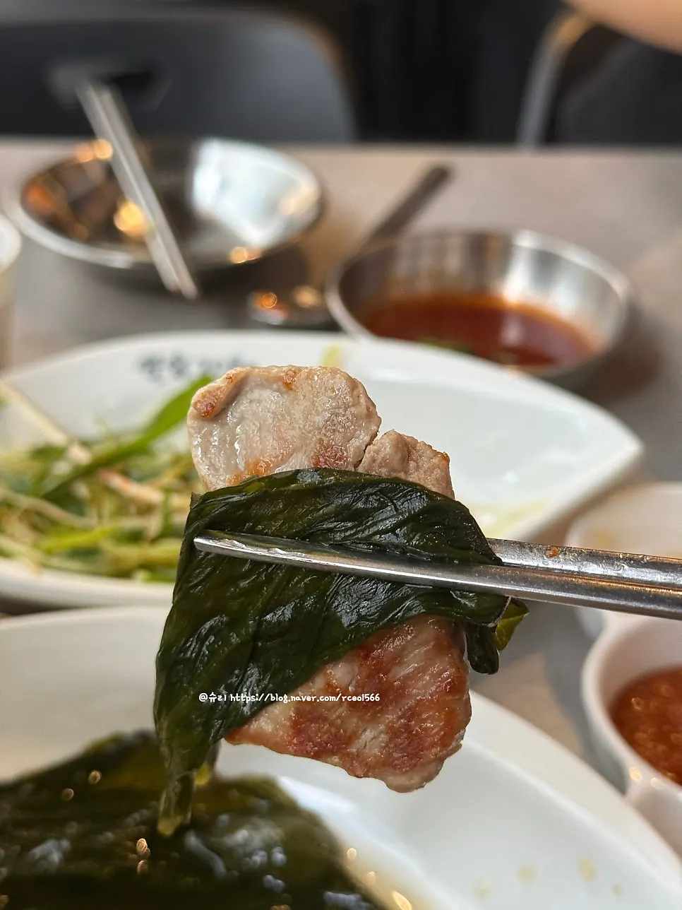 A piece of pork belly wrapped in myeongi-namul