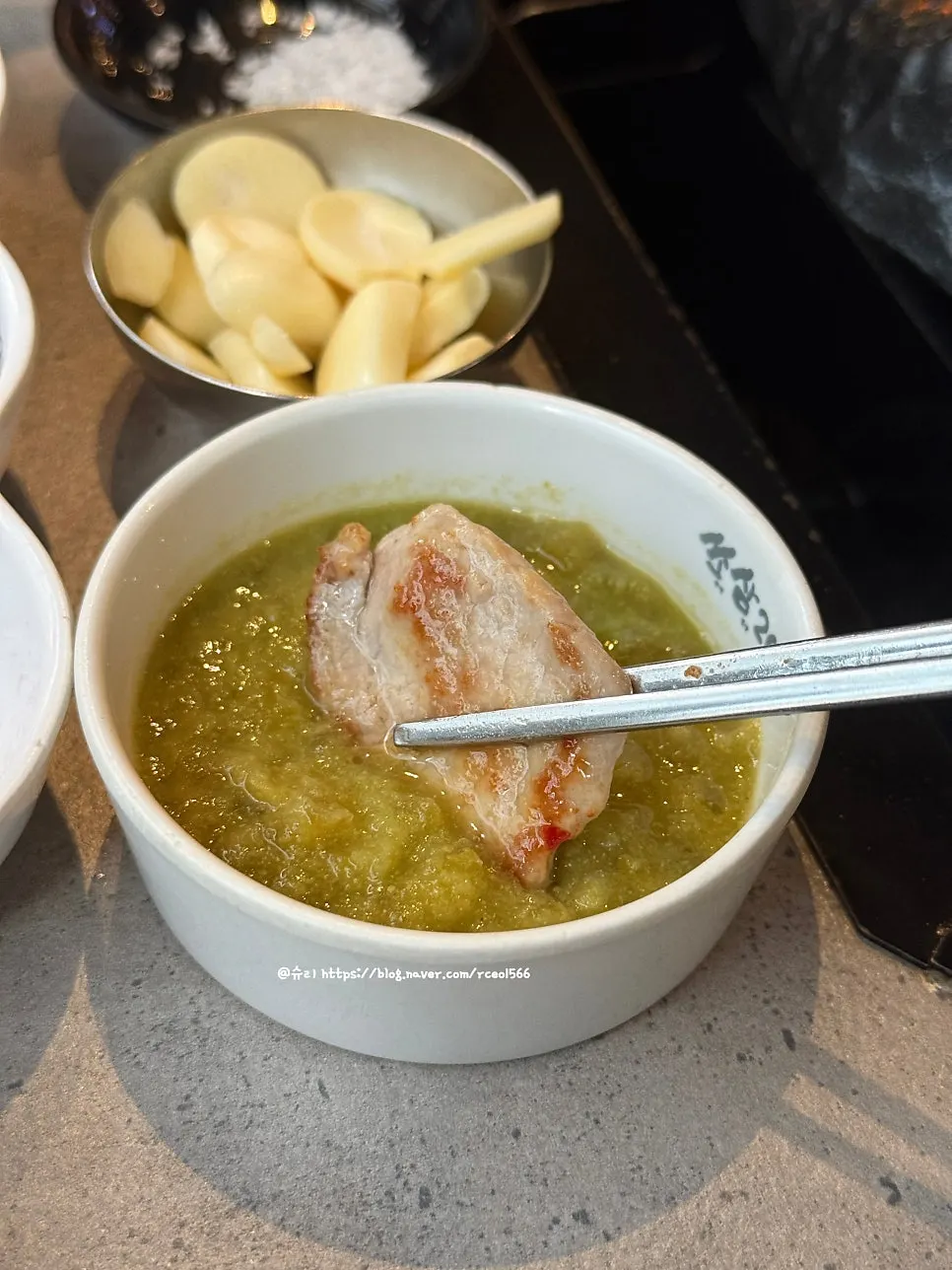 Grilled meat placed on a perilla leaf wrap