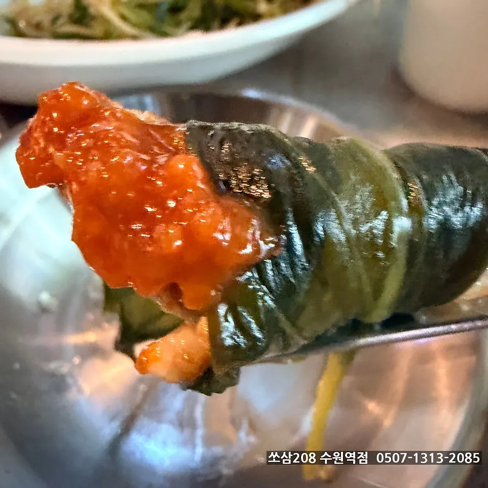 A piece of grilled meat dipped in house special sauce