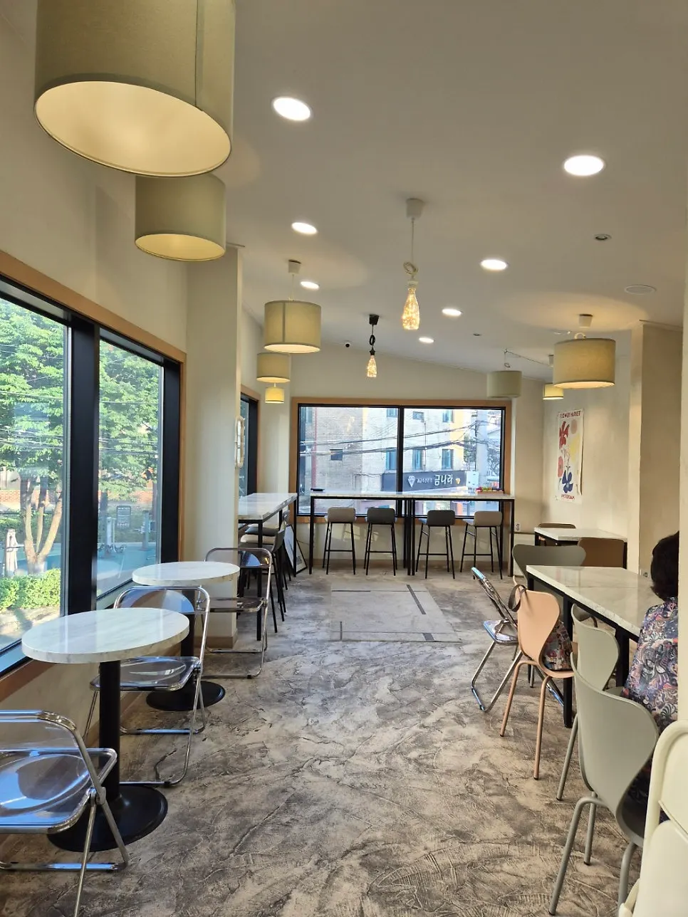 Bright 2nd-floor seating at Stack Bakery with floor-to-ceiling windows