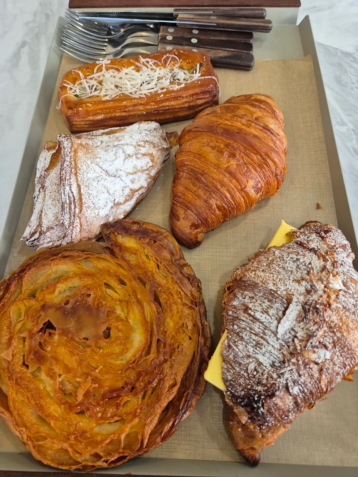 5 ordered croissants and pastries