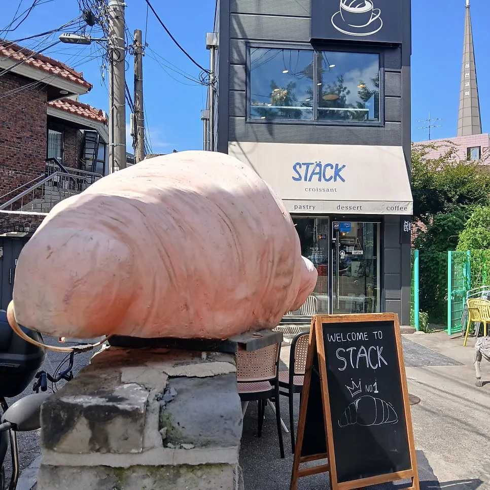 Exterior of Stack Bakery with a large croissant model