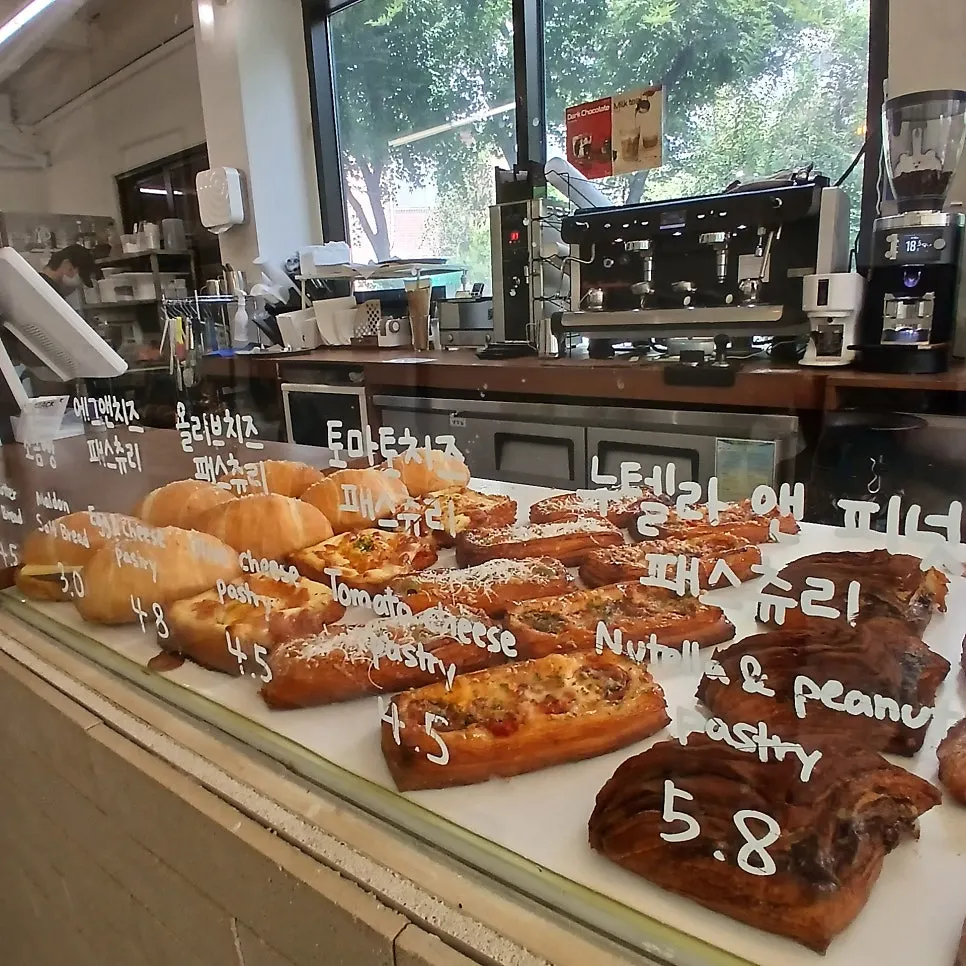 Golden-brown bread lined up in the glass display case