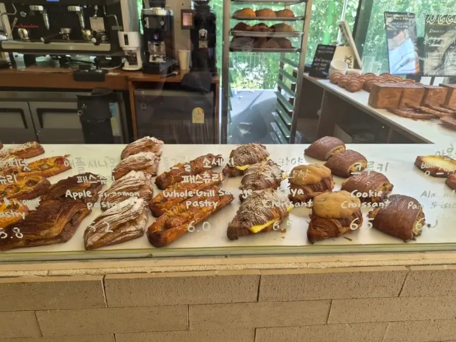 Menu board listing croissants and pastries