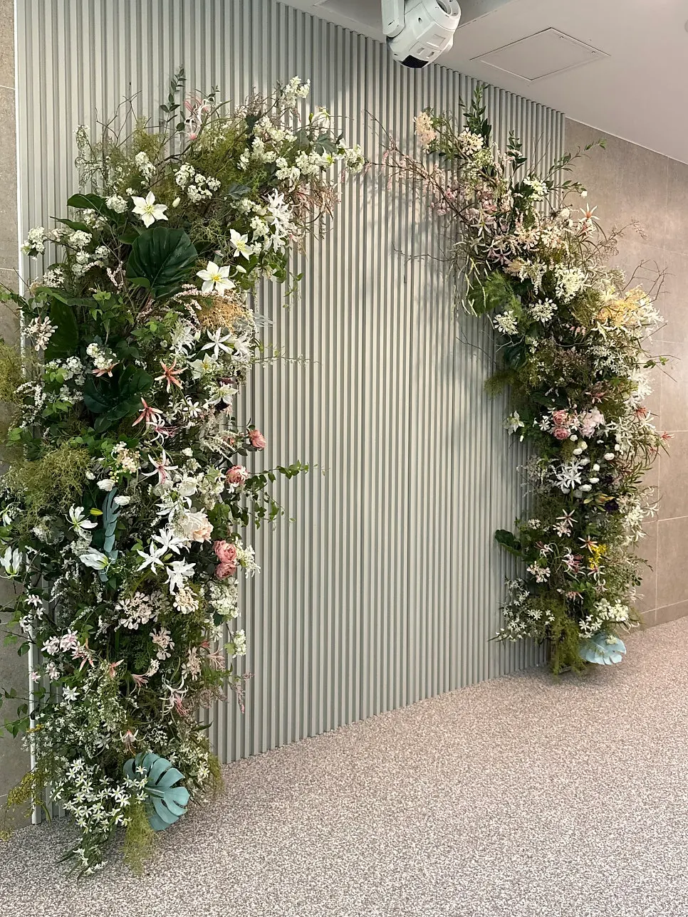 2nd-floor indoor hall entrance with wedding photos and photo zone