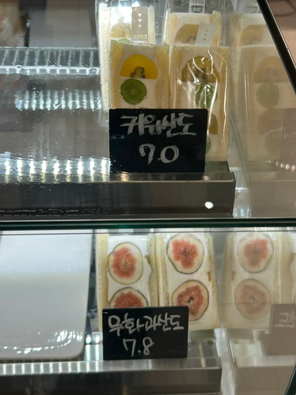 Fig cake and fruit sandwiches inside the showcase