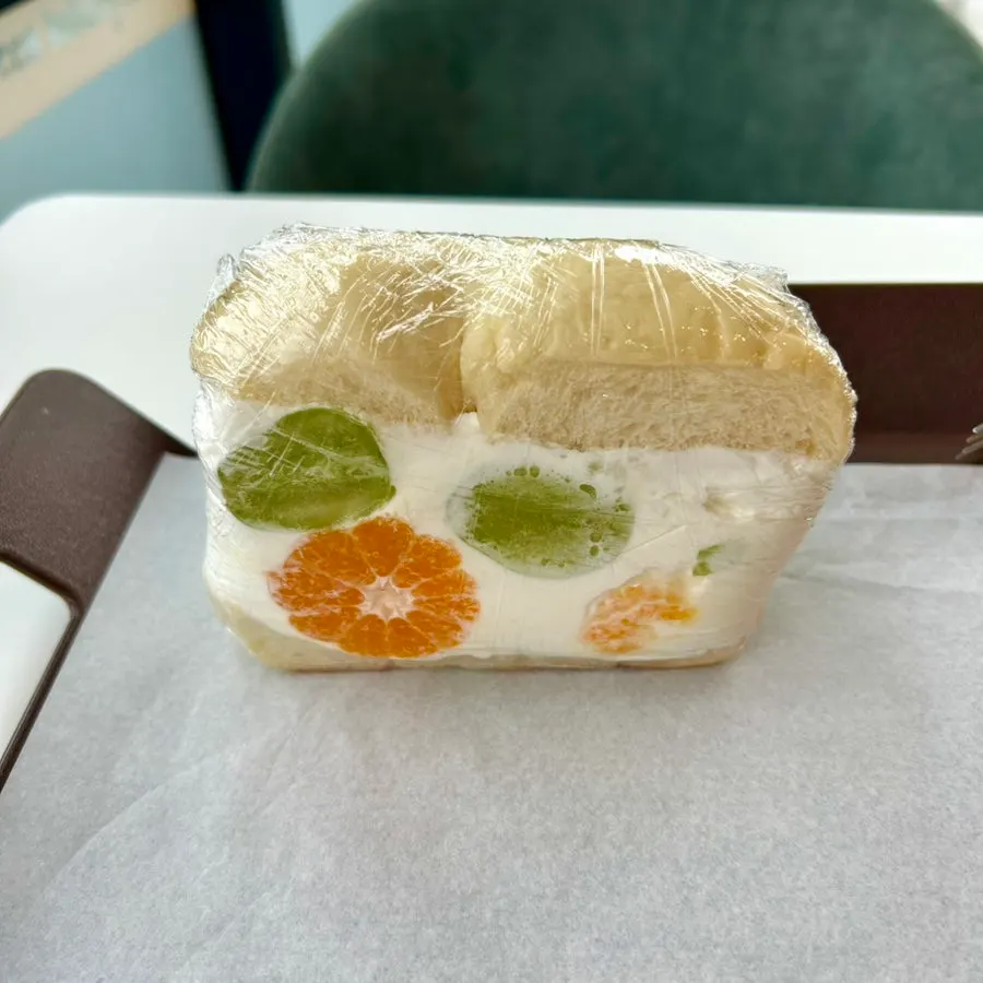 Cross-section of the bagel sando after one bite showing the fresh cream