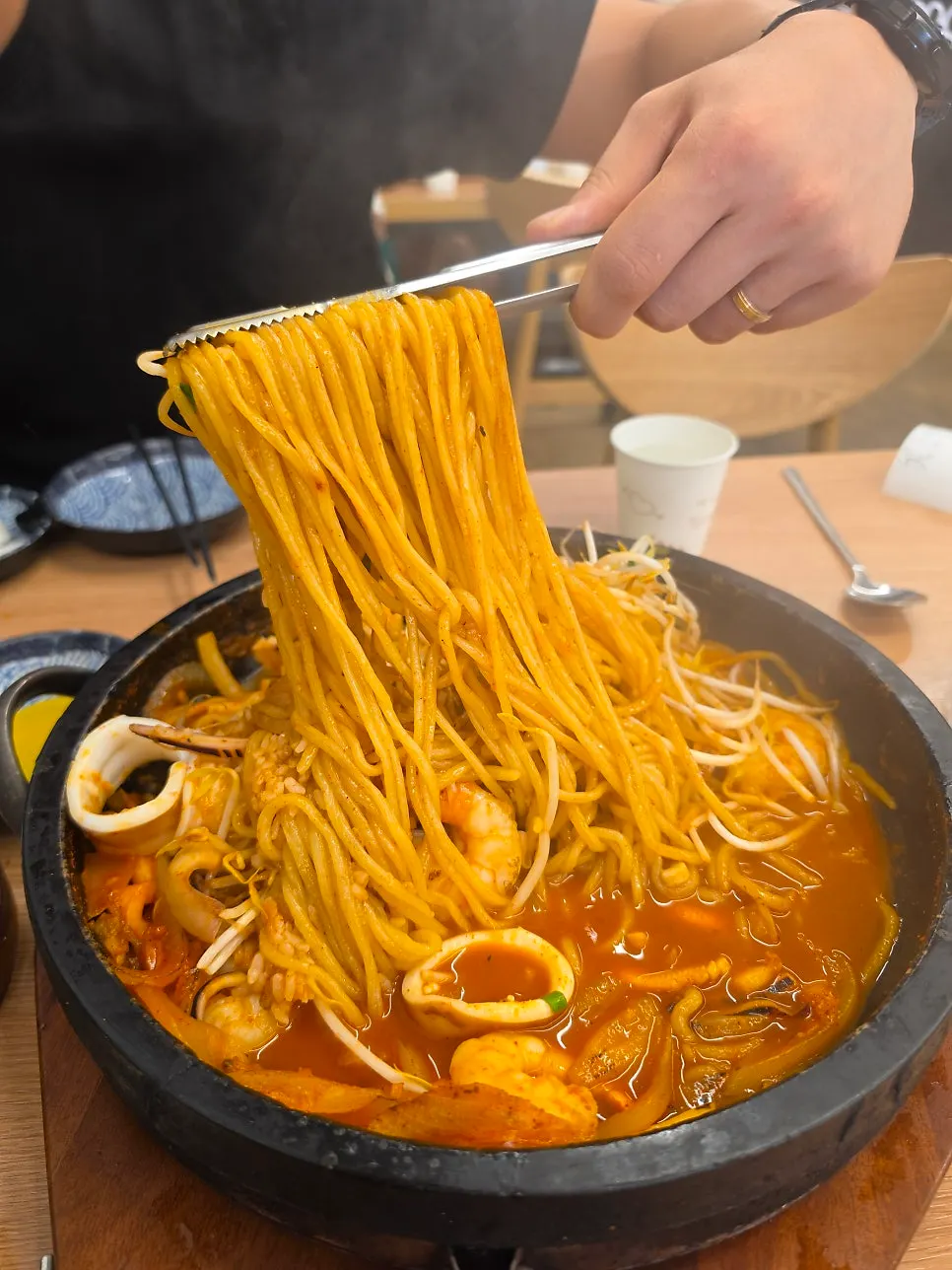 Reduced broth over noodles and shrimp in the stone jjamppong