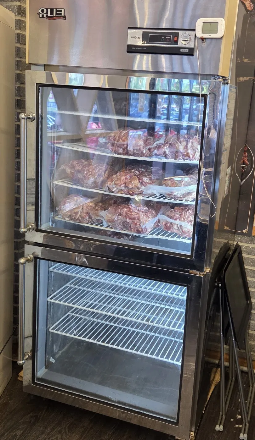 Aging fridge stocked with vacuum-packed raw jjokgalbi