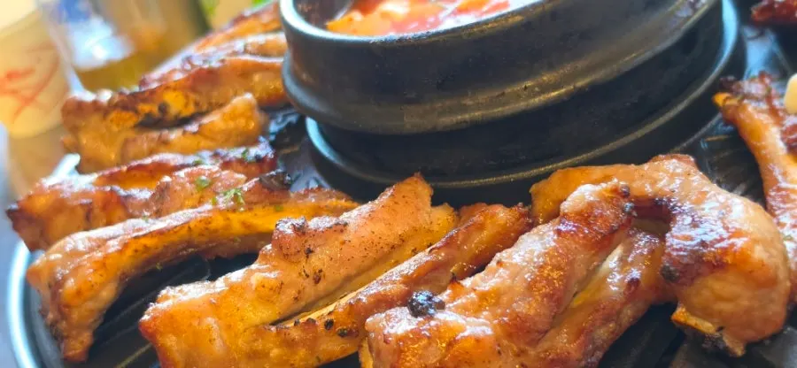 Spicy jjokgalbi served with grilled rice cake