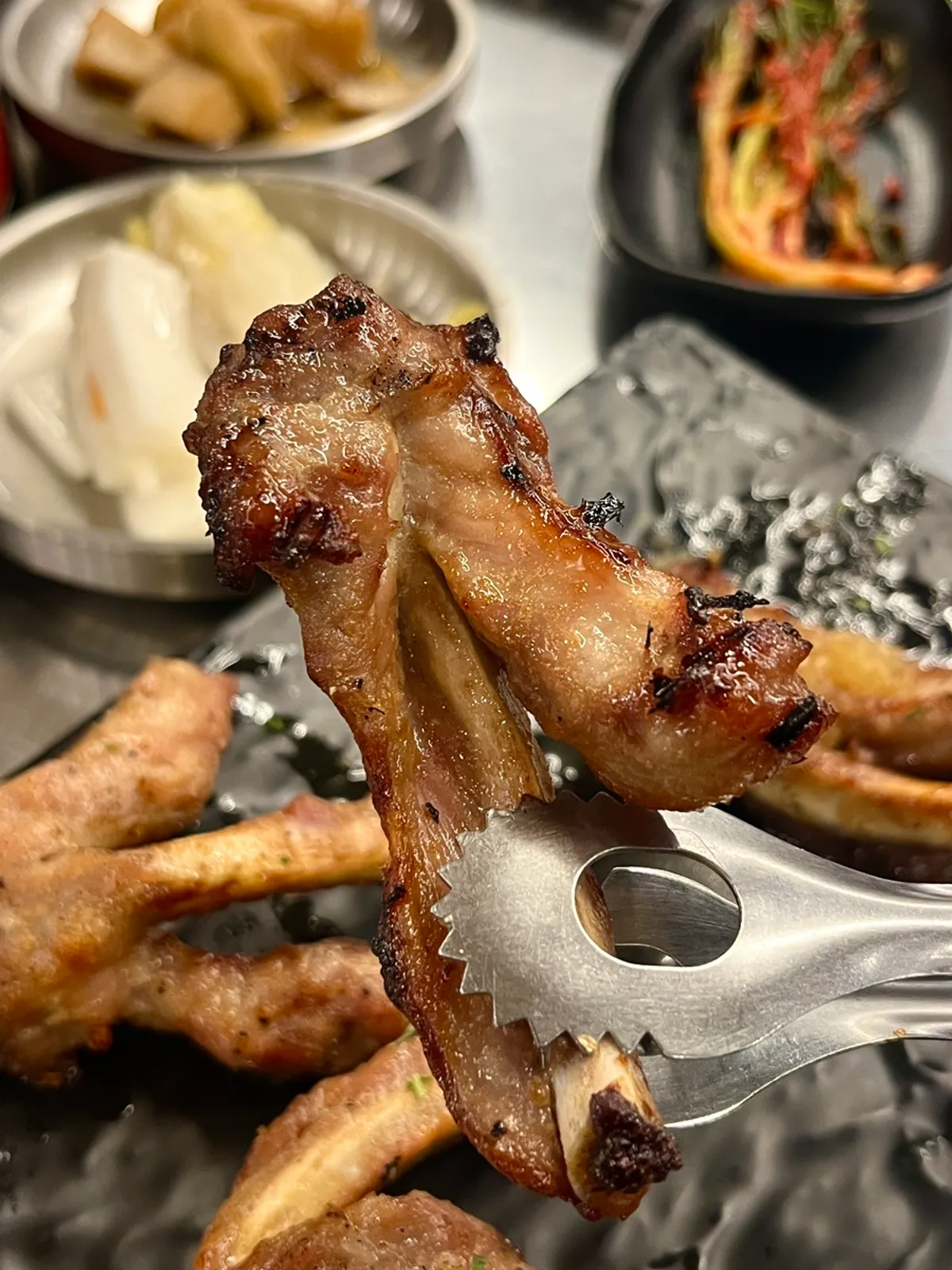 Fully-cooked jjokgalbi being warmed on the grill