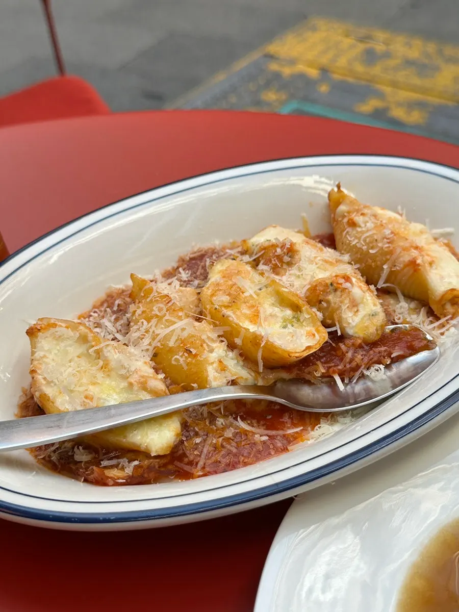 A spoonful of shell pasta cradling sauce