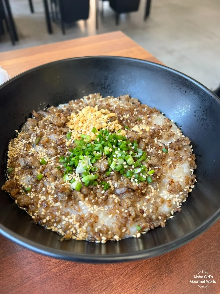 A well-mixed bowl of chicken neck rice porridge