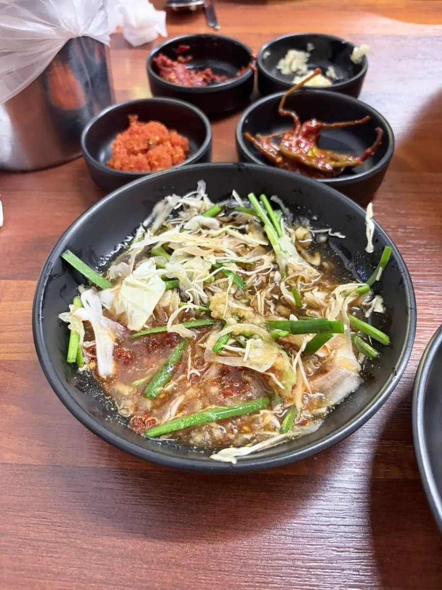 A bowl of chicken neck rice porridge with toppings