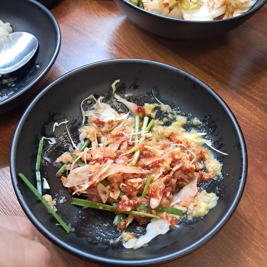 A bowl of pre-meal porridge with chunks of meat inside