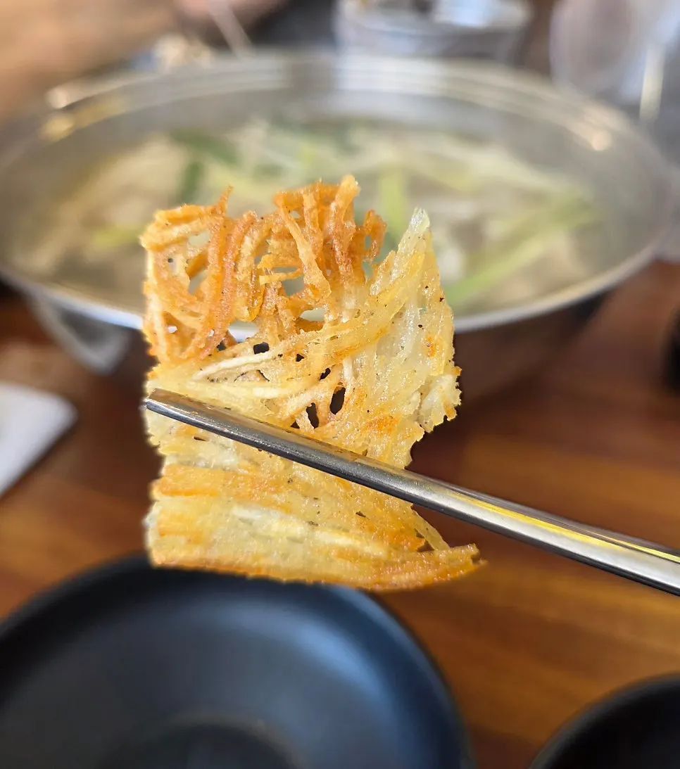 Cross-section of the potato pancake with stretchy cheese