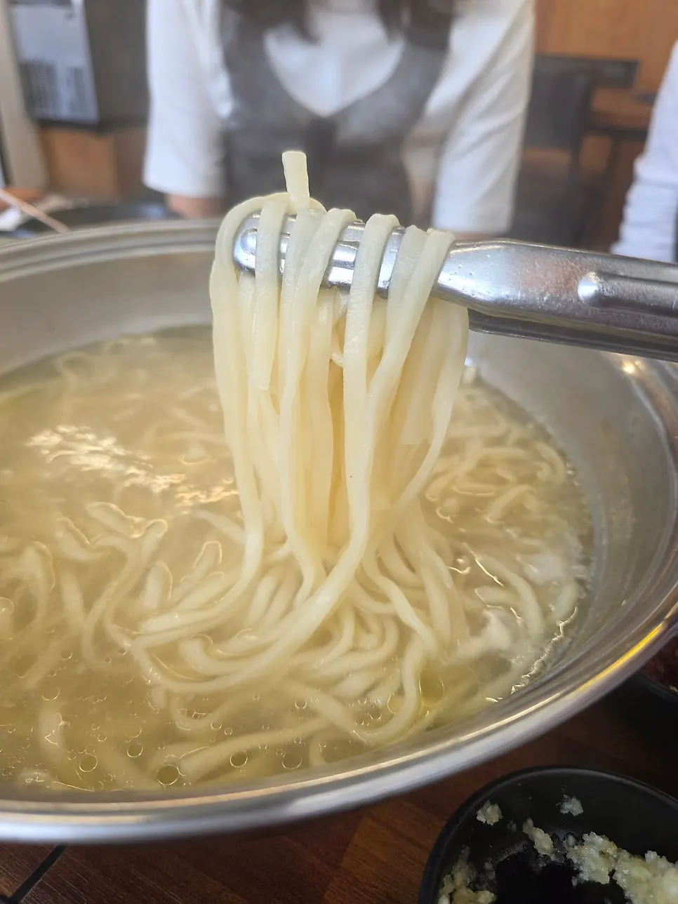 Noodles cooking in the rich broth