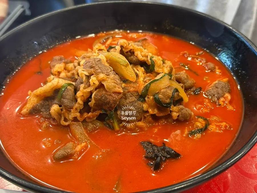 A bowl of jjamppong-bap with deep-colored broth