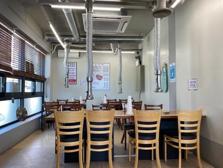 Spacious dining hall at Sujeong Galbi with generous table spacing