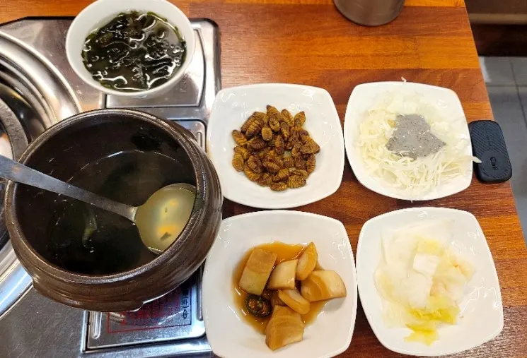 Side dishes including grilled bakdae fish and salad